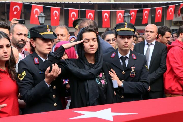 Antalya'da jandarma su altı kurtarma ekibinin dalış eğitiminde rahatsızlanarak şehit olan Jandarma Astsubay Kıdemli Üst Çavuş Mesut Akmeşe, İzmir'in Dikili ilçesinde son yolculuğuna uğurlandı.  Cenazede şehidin eşi Latife Akmeşe (ortada) şehidin tabutunun karşısında asker selamı verdi. ( Metin Aydemir - Anadolu Ajansı )